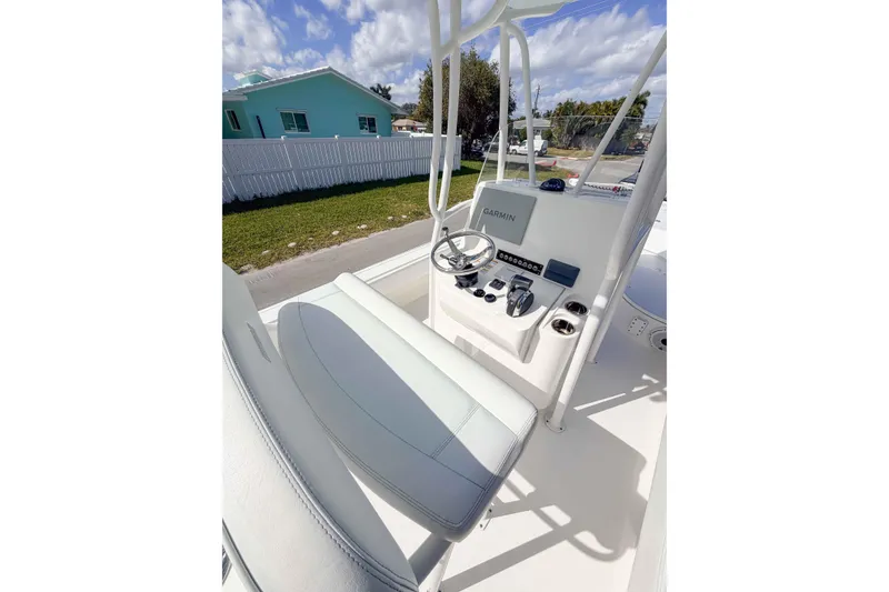 Slide: The Image of 2023 Contender 26 Bay boat console with Garmin navigation, steering wheel, and controls. - 14