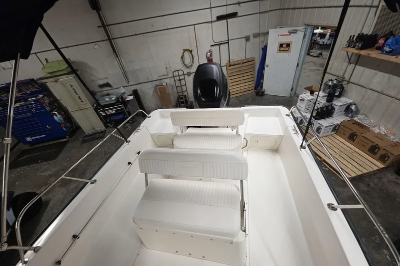 Slide: The Image of 2011 Boston Whaler 190 Montauk boat interior in a workshop setting. - 12
