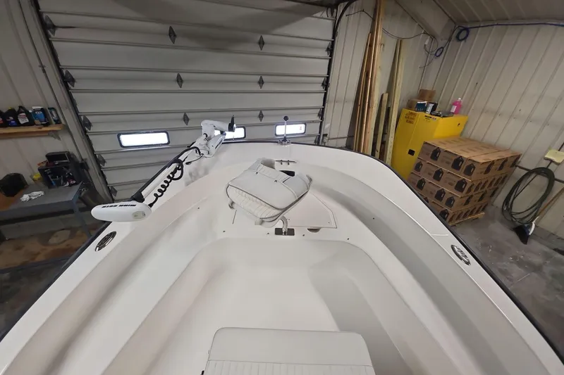 Slide: The Image of 2011 Boston Whaler 190 Montauk boat interior in a garage setting. - 13