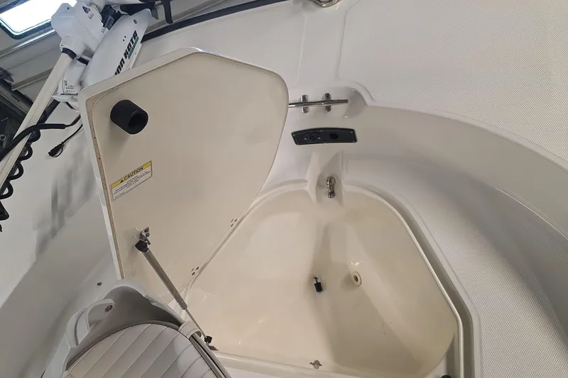 Slide: The Image of 2011 Boston Whaler 190 Montauk boat interior with open storage compartment. - 15