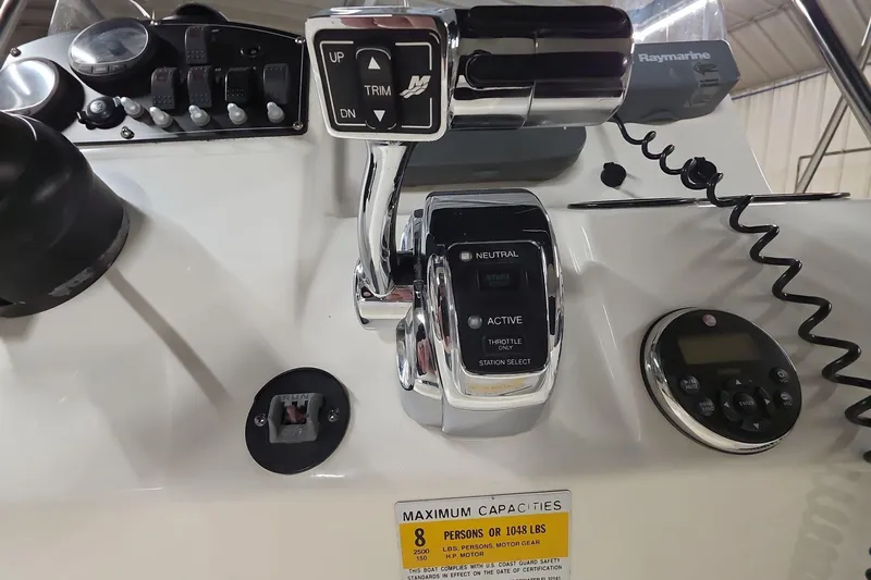 Slide: The Image of Control panel of a 2011 Boston Whaler 190 Montauk boat with throttle and gauges. - 9