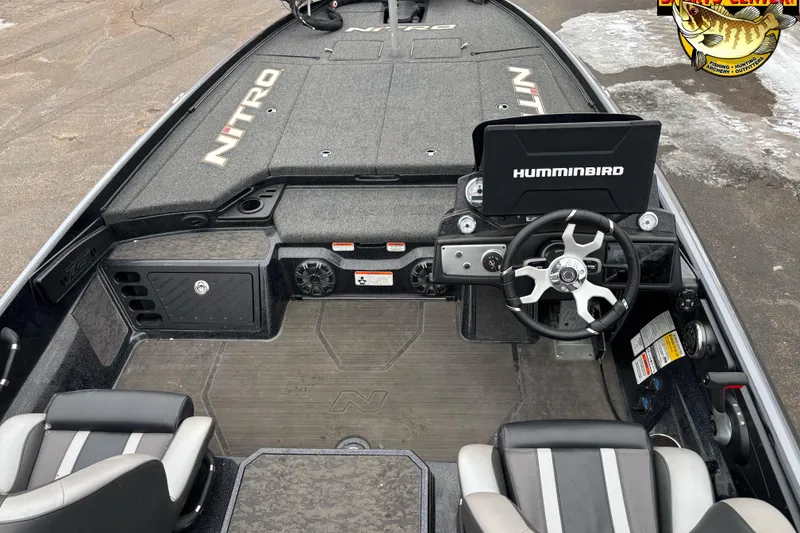 Slide: The Image of 2025 Nitro Z21 XL boat interior with Humminbird electronics and sleek steering wheel design. - 5