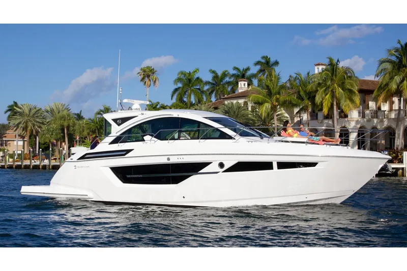 Slide: The Image of 2018 Cruisers Yachts 50 Cantius illuminated at night on the water. - 3