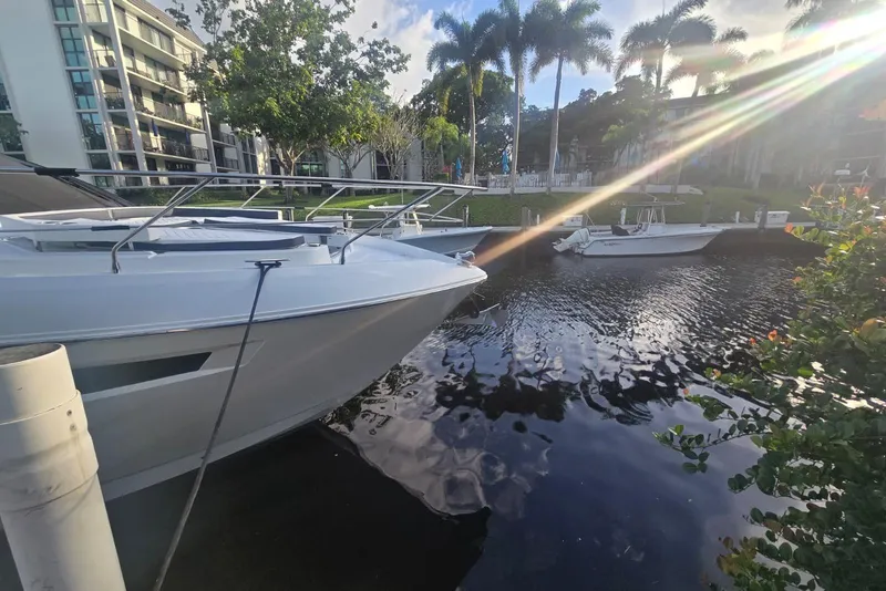 Slide: The Image of 2018 Cruisers Yachts 50 Cantius docked at night, city lights in background. - 32