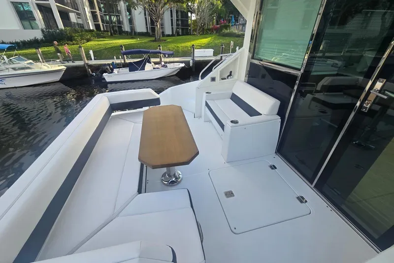 Slide: The Image of 2018 Cruisers Yachts 50 Cantius illuminated at night in a marina setting. - 33