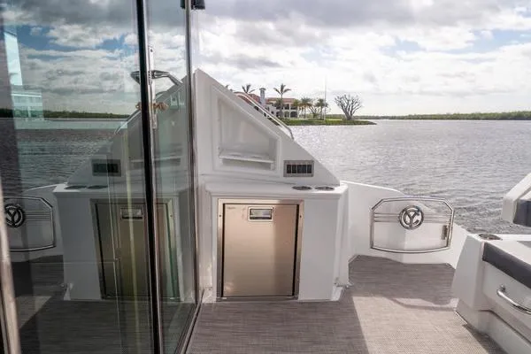 Slide: The Image of 2018 Cruisers Yachts 50 Cantius deck with scenic water view and modern amenities. - 10