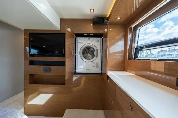 Slide: The Image of Luxury interior of 2018 Cruisers Yachts 50 Cantius with washer and TV. - 23