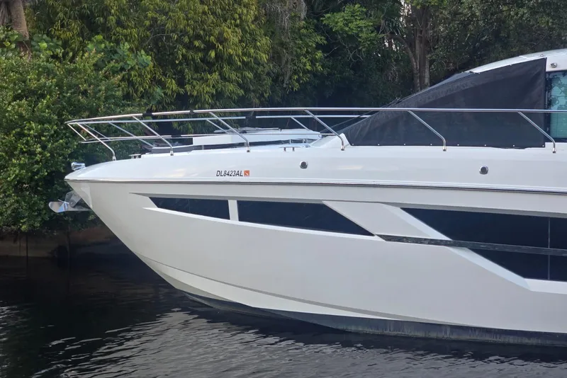 Slide: The Image of 2018 Cruisers Yachts 50 Cantius docked near lush greenery. - 30