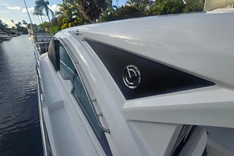 Slide: The Image of 2018 Cruisers Yachts 50 Cantius, sleek design, docked by palm-lined waterway. - 35