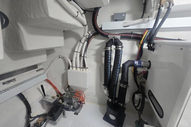 Slide: The Image of Engine room of 2018 Cruisers Yachts 50 Cantius with visible pipes and equipment. - 48