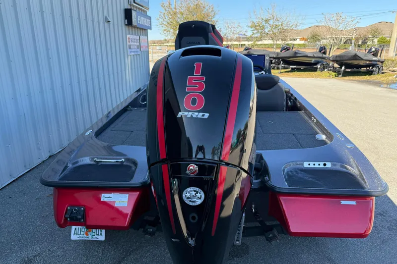 Slide: The Image of 2022 Caymas CX 18 SS boat with 150 Pro engine, parked outdoors. - 9