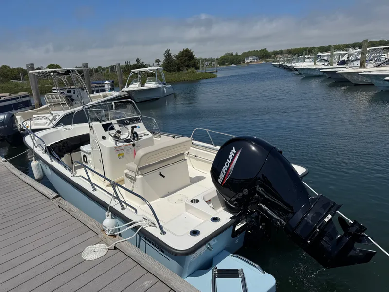 Slide: The Image of Boston Whaler 190 Montauk 2025 at dock with Mercury engine. - 2