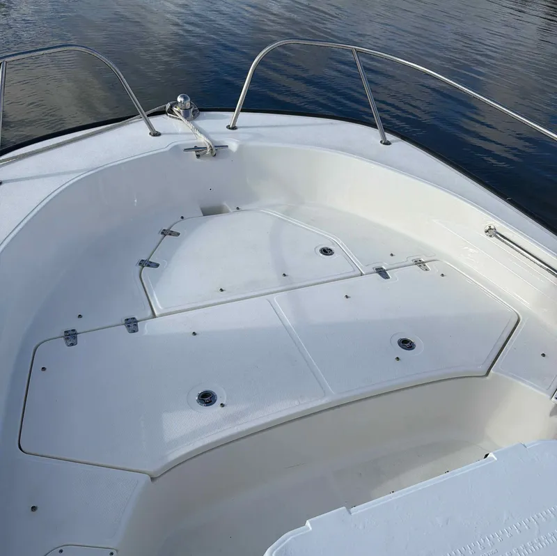 Slide: The Image of Boston Whaler 190 Montauk 2025, spacious deck on calm water. - 6