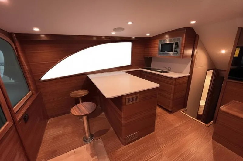 Slide: The Image of Luxurious 2026 Weaver Sportfish yacht interior with modern kitchen and wooden finishes. - 2
