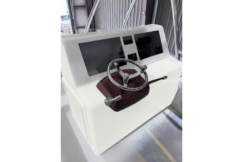 Slide: The Image of Helm of 2026 Weaver Sportfish boat with modern controls and dual screens. - 5