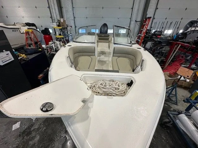 Slide: The Image of Key West 203 DFS 2025 boat in storage with open hatch. - 13