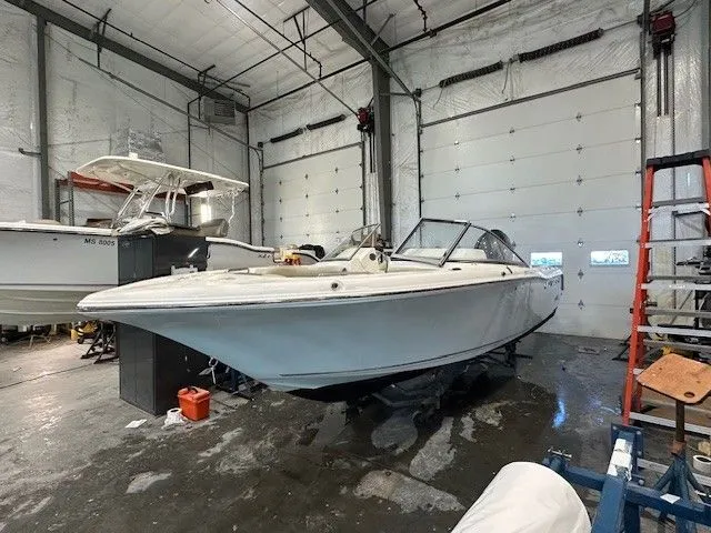 Slide: The Image of Key West 203 DFS 2025 boat in storage facility. - 2