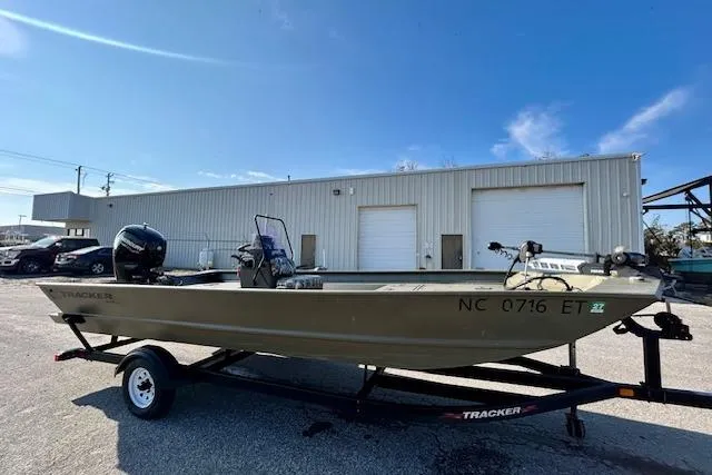 The Image of 2021 Tracker Grizzly 2072 CC boat on trailer, parked outside industrial building. - 0