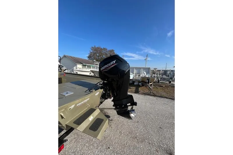 Slide: The Image of 2021 Tracker Grizzly 2072 CC boat with Mercury outboard motor in outdoor setting. - 10