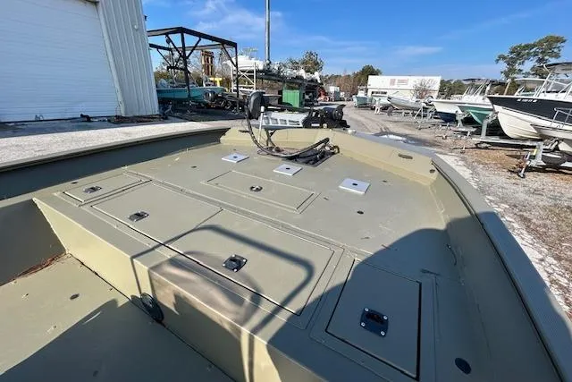 Slide: The Image of 2021 Tracker Grizzly 2072 CC boat in outdoor storage area, showcasing spacious deck layout. - 6