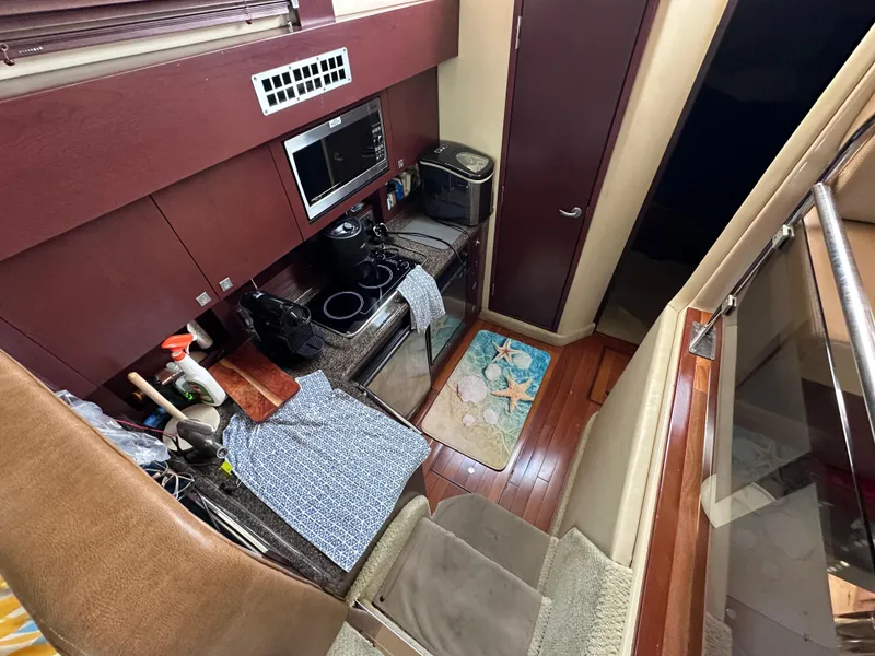 Slide: The Image of Compact kitchen on a 2007 Sea Ray 36 Sedan Bridge yacht. - 25