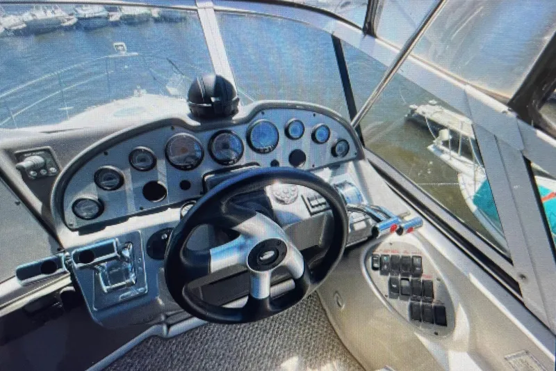 Slide: The Image of 2006 Cruisers Yachts 385 Motoryacht helm with steering wheel and control panel. - 10