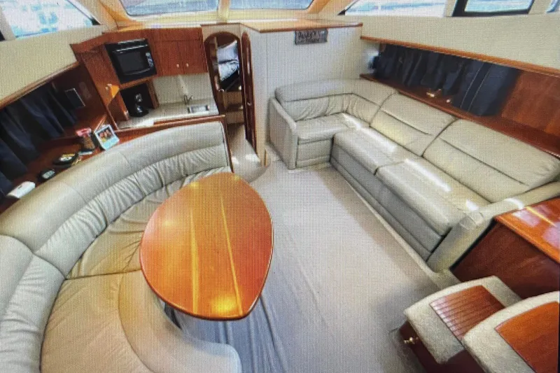 Slide: The Image of Luxurious interior of 2006 Cruisers Yachts 385 Motoryacht with plush seating and kitchenette. - 16