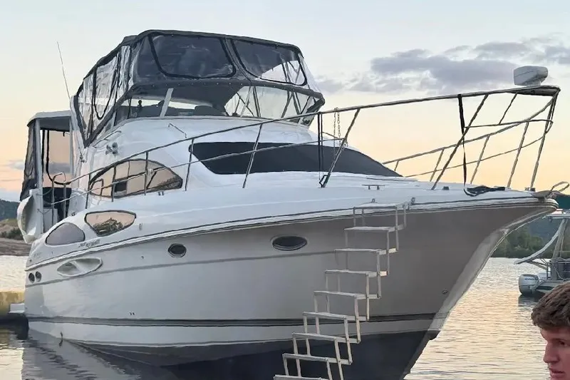Slide: The Image of 2006 Cruisers Yachts 385 Motoryacht docked at sunset with ladder access. - 2