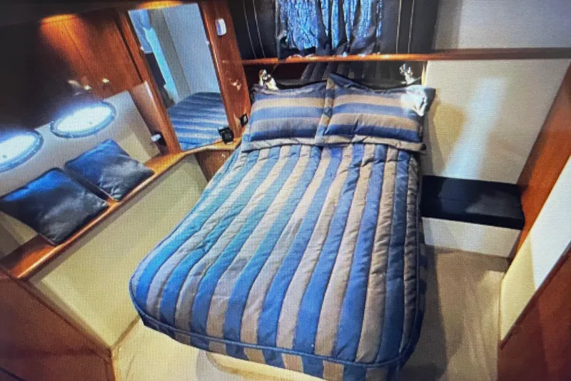 Slide: The Image of Luxurious bedroom interior of 2006 Cruisers Yachts 385 Motoryacht with striped bedding. - 20