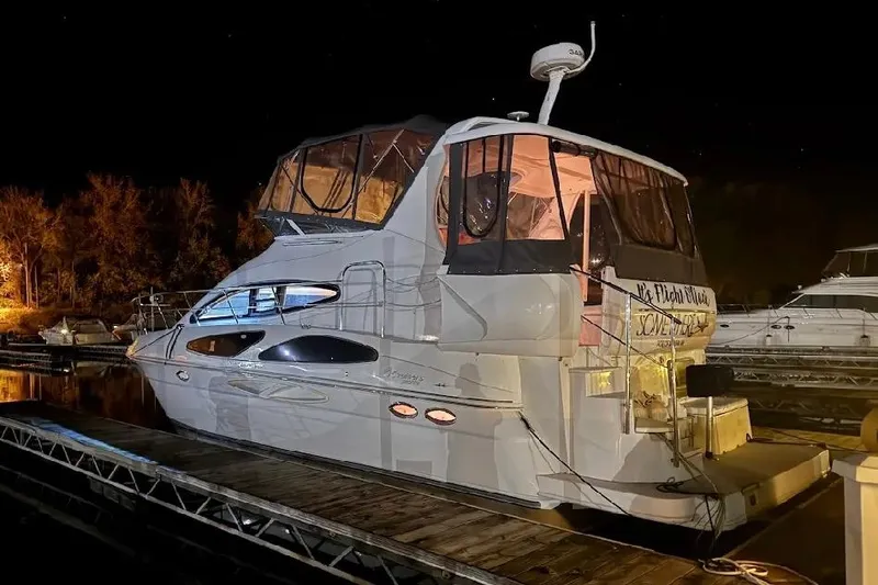 Slide: The Image of 2006 Cruisers Yachts 385 Motoryacht docked at night, illuminated by soft lighting. - 3