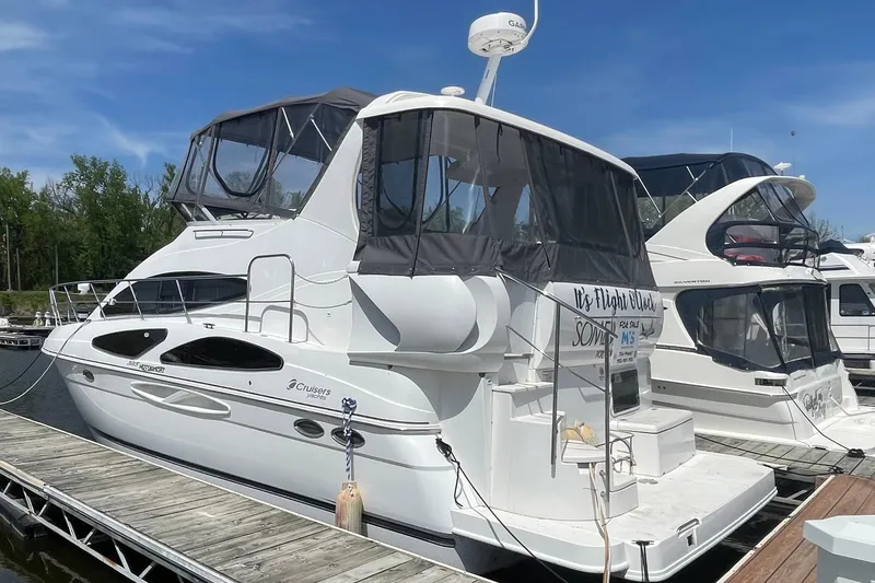 Slide: The Image of 2006 Cruisers Yachts 385 Motoryacht docked, featuring sleek design and spacious upper deck. - 31