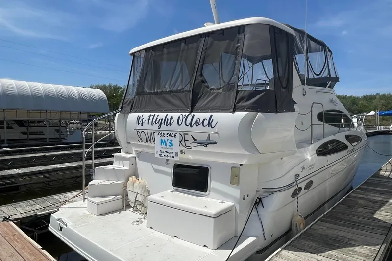 Slide: The Image of 2006 Cruisers Yachts 385 Motoryacht docked, featuring "It's Flight O'Clock" signage. - 32