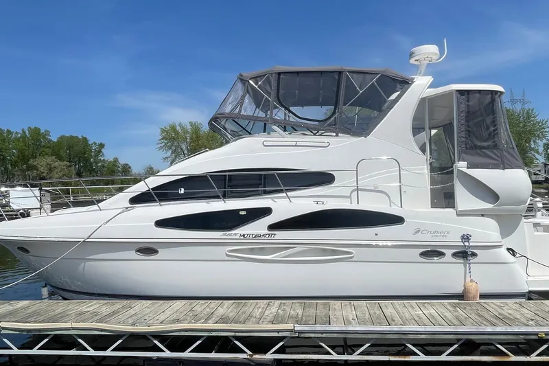 Slide: The Image of 2006 Cruisers Yachts 385 Motoryacht docked, featuring sleek design and spacious upper deck. - 35