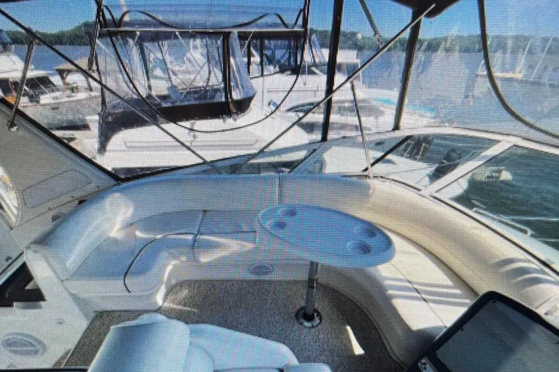 Slide: The Image of 2006 Cruisers Yachts 385 Motoryacht interior with seating and table, docked at marina. - 4