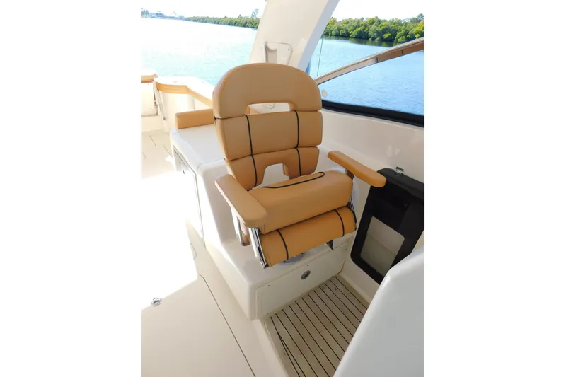 Slide: The Image of Luxurious seating on 2015 Scout 275 Dorado boat with scenic water view. - 14