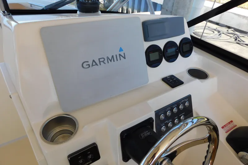 Slide: The Image of 2015 Scout 275 Dorado boat dashboard with Garmin navigation system and controls. - 15