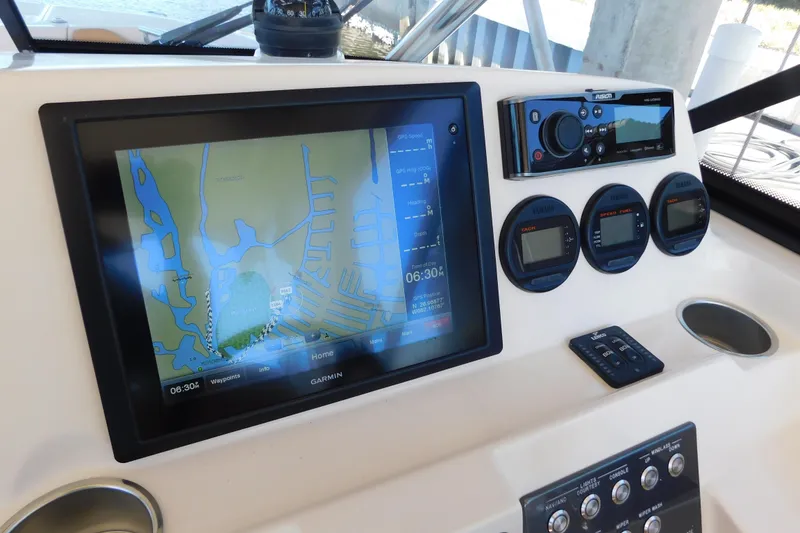 Slide: The Image of Control panel of 2015 Scout 275 Dorado boat with navigation and gauges. - 16