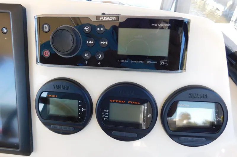 Slide: The Image of Control panel of a 2015 Scout 275 Dorado boat with Yamaha gauges and Fusion audio system. - 18