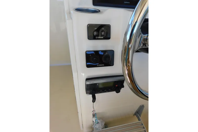 Slide: The Image of Control panel of 2015 Scout 275 Dorado boat with Yamaha controls and steering wheel. - 19
