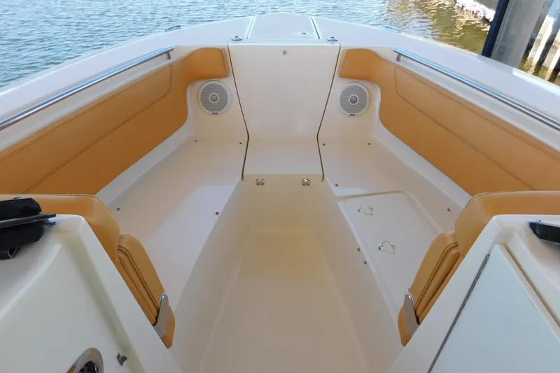 Slide: The Image of 2015 Scout 275 Dorado boat interior with tan seating and speakers. - 22