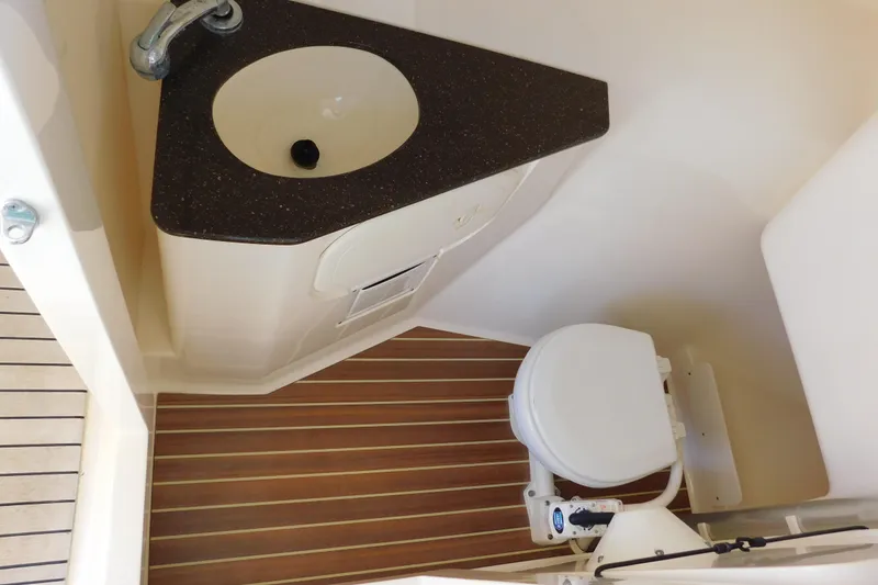 Slide: The Image of 2015 Scout 275 Dorado boat bathroom with sink and toilet. - 24