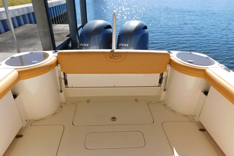Slide: The Image of 2015 Scout 275 Dorado boat interior with twin Yamaha 200 engines by the water. - 27