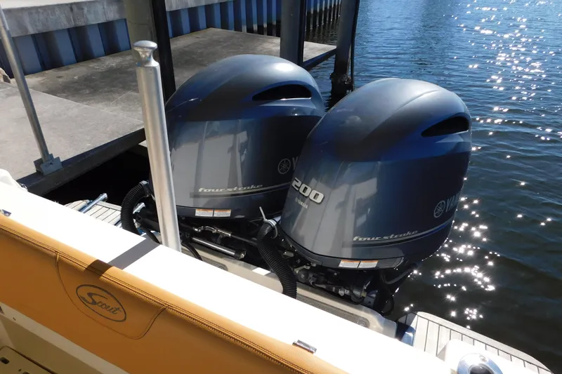 Slide: The Image of 2015 Scout 275 Dorado with twin Yamaha 200 outboard engines docked by water. - 30