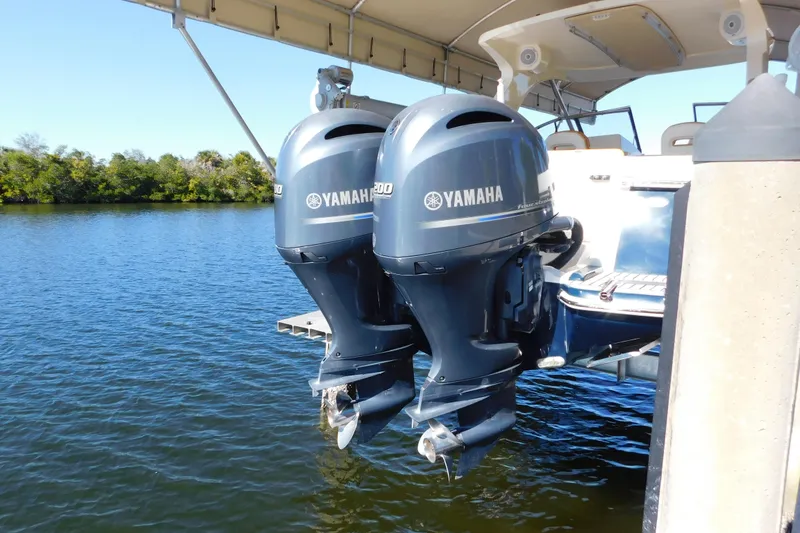 Slide: The Image of 2015 Scout 275 Dorado with twin Yamaha outboard motors on a calm lake. - 32