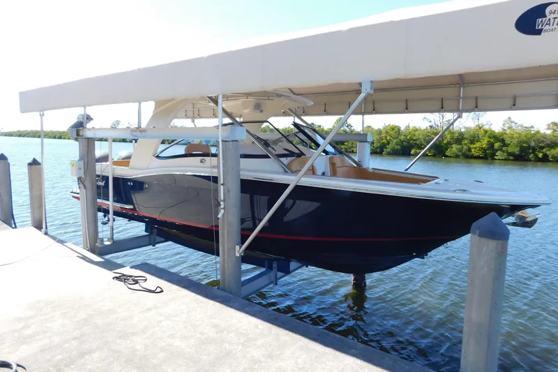 Slide: The Image of 2015 Scout 275 Dorado boat on lift by waterfront dock. - 34