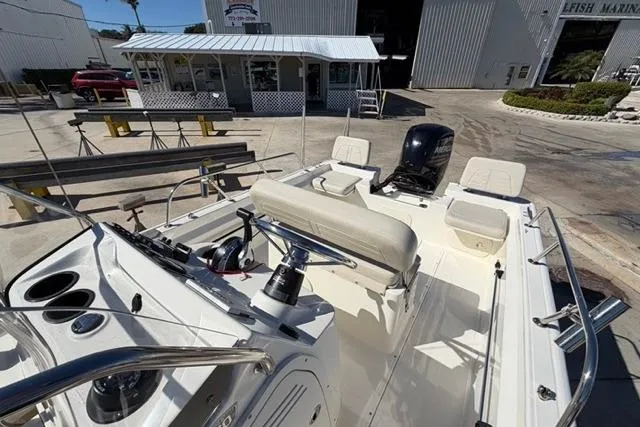 Slide: The Image of 2018 Boston Whaler 170 Montauk boat with seating and console, docked at a marina. - 12