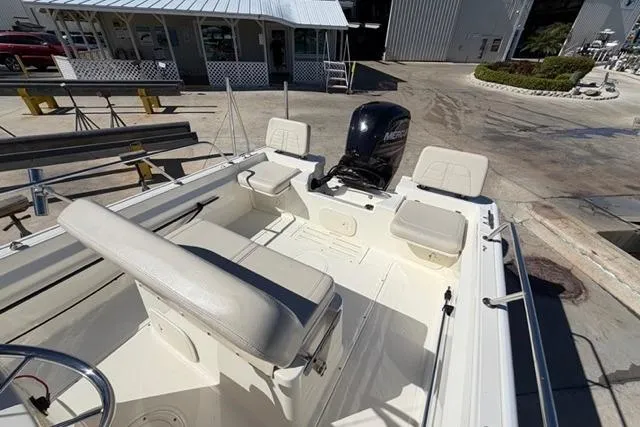 Slide: The Image of 2018 Boston Whaler 170 Montauk boat interior with seating and Mercury outboard motor. - 13
