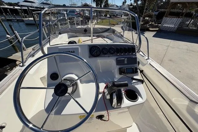 Slide: The Image of 2018 Boston Whaler 170 Montauk boat dashboard with steering wheel and controls. - 18