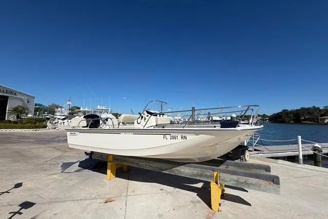 Slide: The Image of 2018 Boston Whaler 170 Montauk boat on dock, clear sky, marina background. - 2