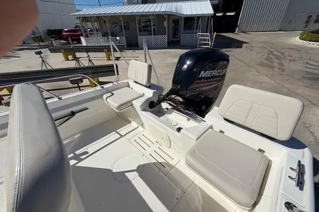 Slide: The Image of 2018 Boston Whaler 170 Montauk boat interior with Mercury engine, docked outdoors. - 20